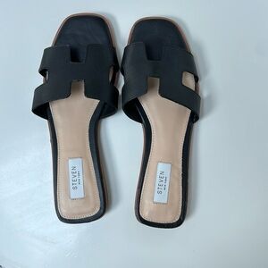 Steven black leather slides, similar to Tory Burch design